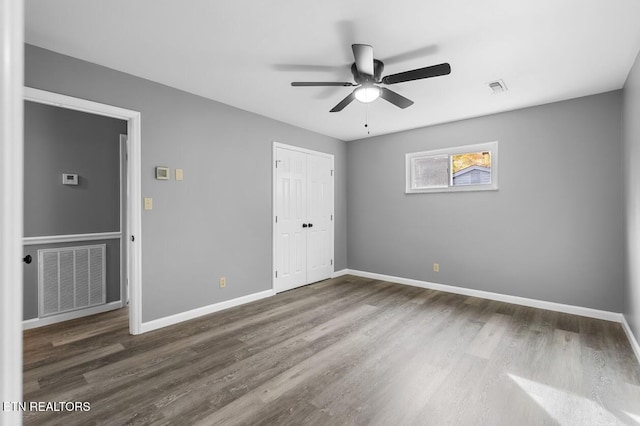 unfurnished bedroom featuring hardwood / wood-style flooring and ceiling fan