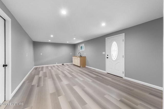 entrance foyer featuring wet bar and light hardwood / wood-style flooring