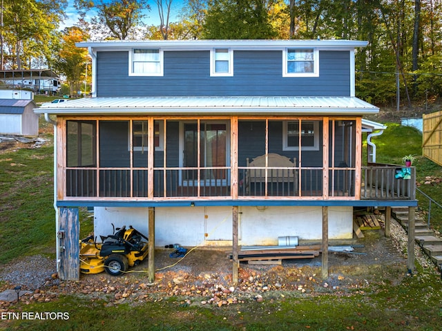 back of property with a sunroom