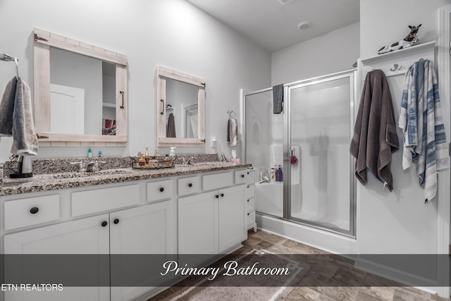 bathroom featuring vanity and a shower with shower door