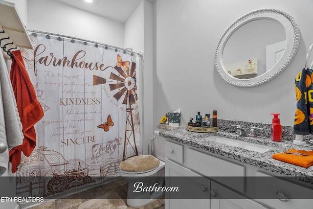 bathroom with vanity, toilet, and walk in shower