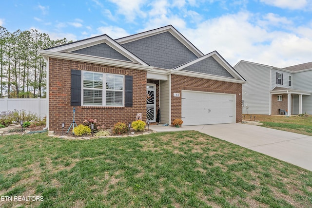 view of front of house with a front yard and a garage