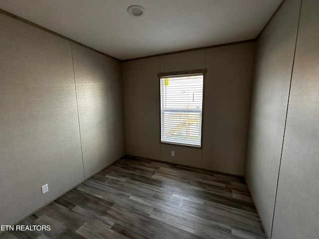 spare room featuring crown molding and light hardwood / wood-style flooring