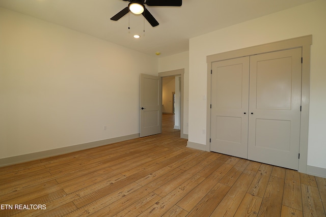 unfurnished bedroom with recessed lighting, baseboards, a closet, and light wood-type flooring