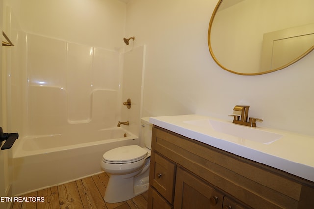 full bathroom featuring  shower combination, vanity, hardwood / wood-style floors, and toilet