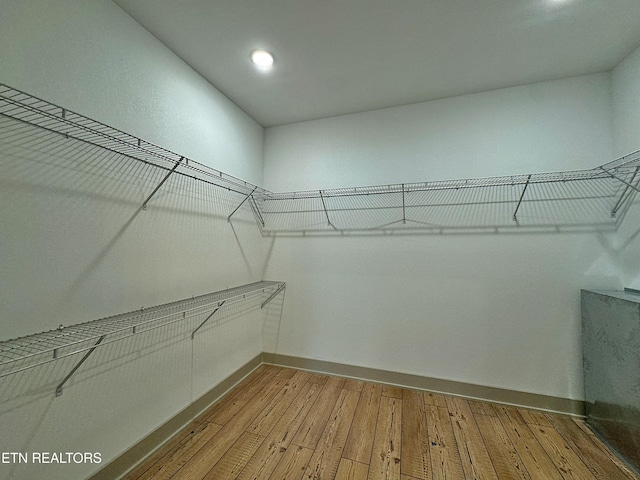 walk in closet featuring hardwood / wood-style flooring