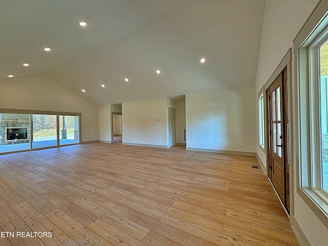unfurnished room with visible vents, light wood-type flooring, baseboards, high vaulted ceiling, and recessed lighting