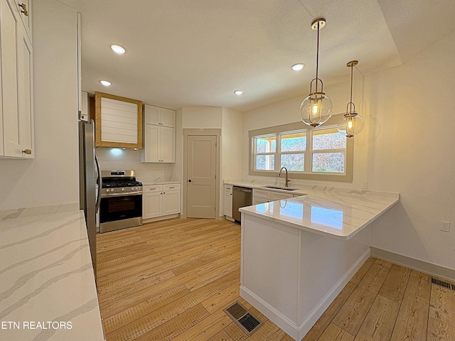 kitchen featuring light hardwood / wood-style flooring, kitchen peninsula, stainless steel appliances, sink, and white cabinetry