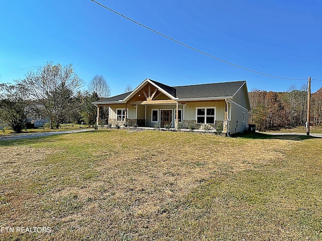 view of front of home with a front yard and covered porch