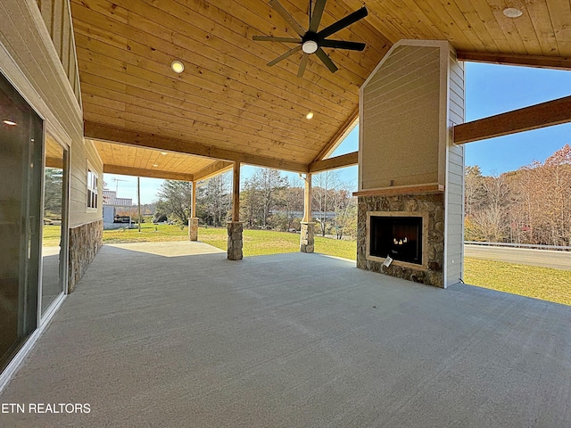 view of patio / terrace with ceiling fan and an outdoor stone fireplace