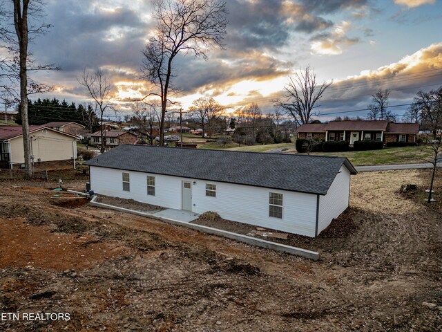 view of back house at dusk