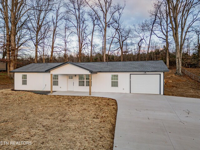 ranch-style home with covered porch and a garage