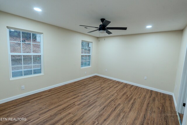 unfurnished room with ceiling fan and dark hardwood / wood-style flooring