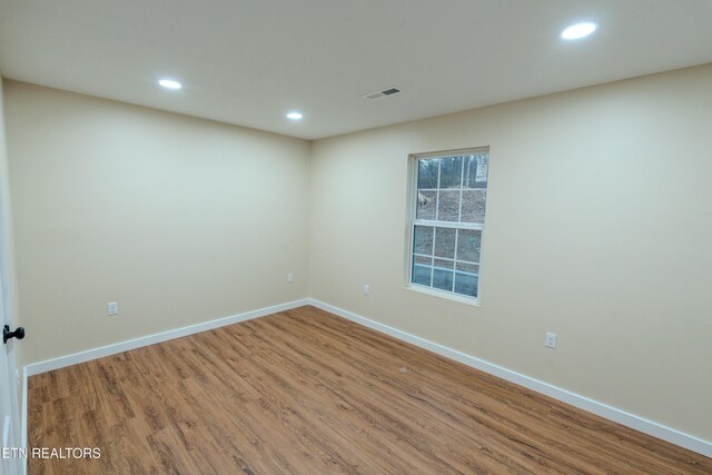 spare room featuring wood-type flooring