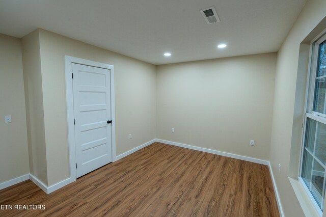 unfurnished room with wood-type flooring