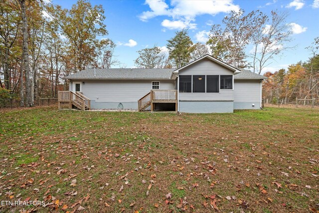 back of property featuring a sunroom and a yard