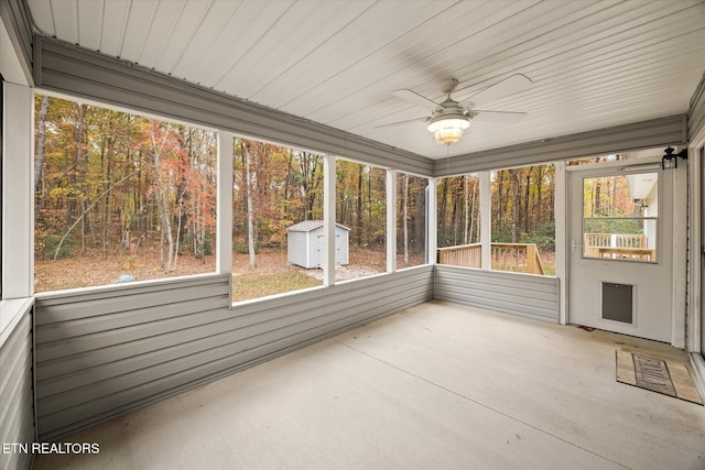 unfurnished sunroom featuring ceiling fan