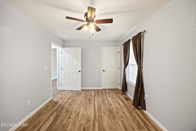 unfurnished bedroom with wood-type flooring and ceiling fan