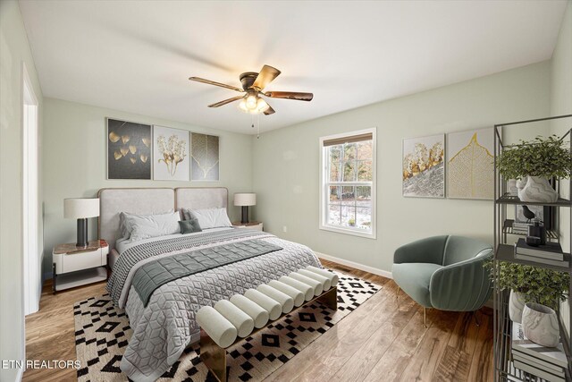 bedroom with hardwood / wood-style floors and ceiling fan