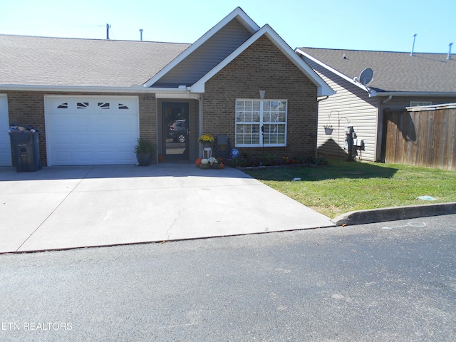 single story home featuring a front yard and a garage