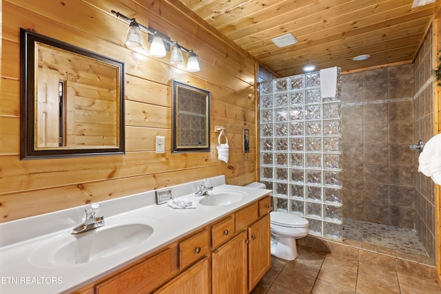 bathroom featuring wooden ceiling, tile patterned flooring, vanity, tiled shower, and wooden walls