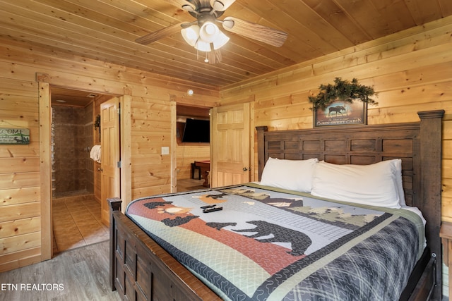 bedroom featuring hardwood / wood-style flooring, wooden walls, ceiling fan, and wood ceiling