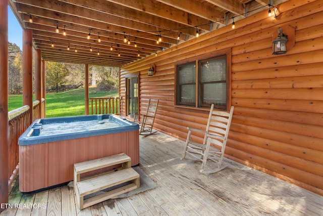 wooden deck featuring a hot tub