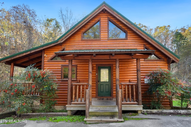 log home featuring a porch