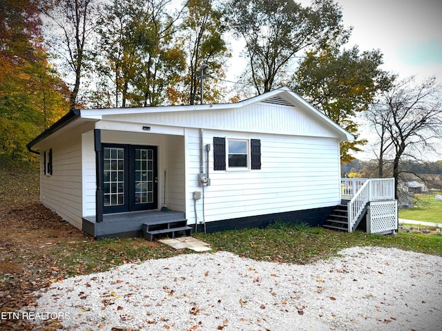 bungalow-style home featuring french doors and covered porch