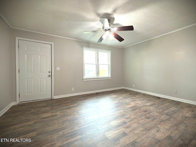 empty room featuring ceiling fan, a textured ceiling, dark hardwood / wood-style flooring, and crown molding