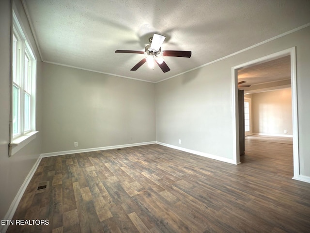 unfurnished room featuring dark wood-type flooring, a wealth of natural light, and a textured ceiling