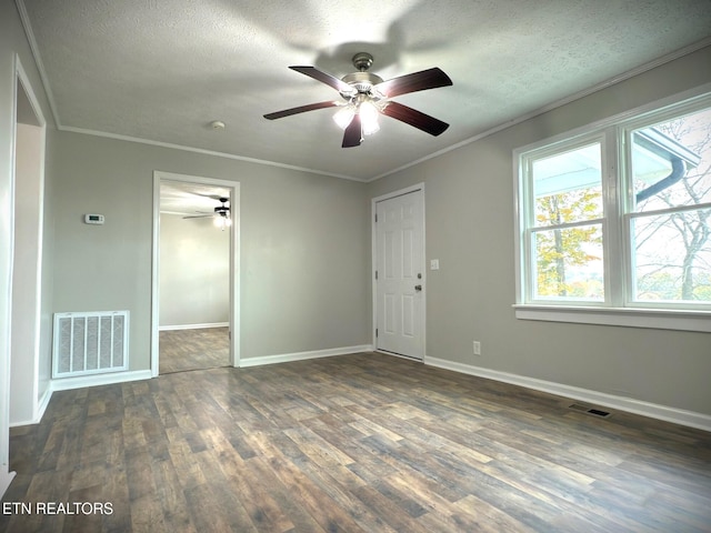 spare room with ornamental molding, ceiling fan, a textured ceiling, and dark hardwood / wood-style floors