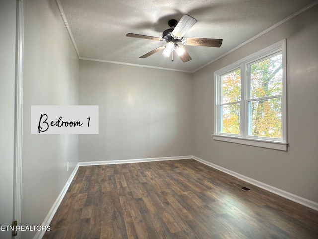 spare room with a textured ceiling, dark wood-type flooring, ceiling fan, and crown molding