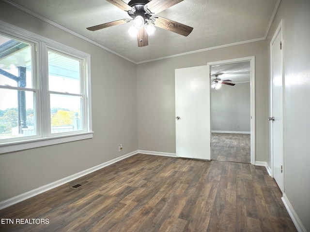 unfurnished bedroom with a textured ceiling, dark hardwood / wood-style flooring, ceiling fan, and crown molding