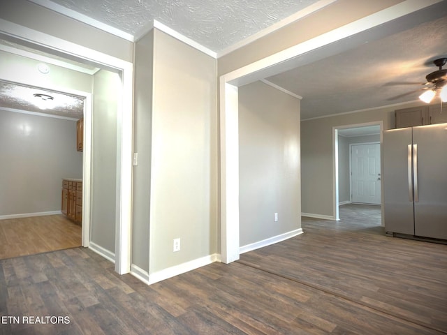 interior space featuring ornamental molding, dark wood-type flooring, and ceiling fan