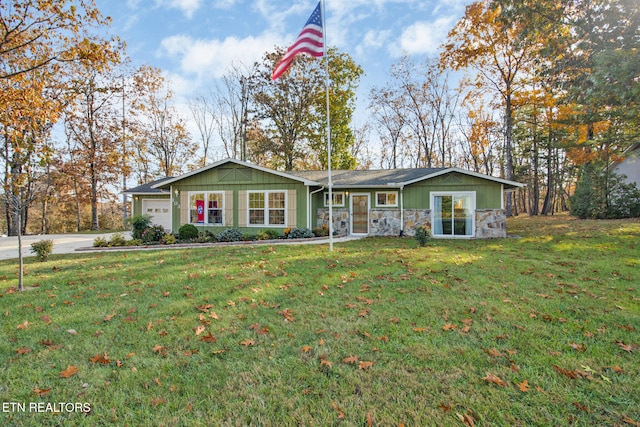 single story home with a garage and a front lawn