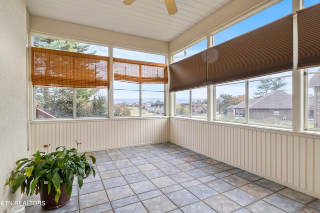 unfurnished sunroom featuring ceiling fan