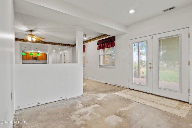 interior space with french doors, ceiling fan, and concrete floors