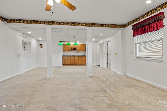 unfurnished living room featuring ceiling fan