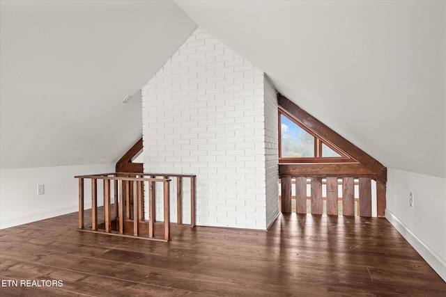 bonus room with lofted ceiling and dark hardwood / wood-style flooring