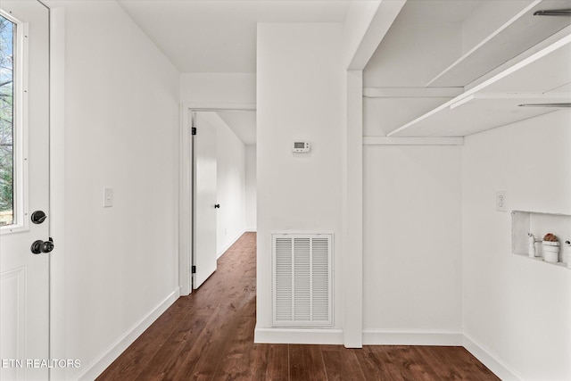 clothes washing area with a healthy amount of sunlight and dark hardwood / wood-style flooring