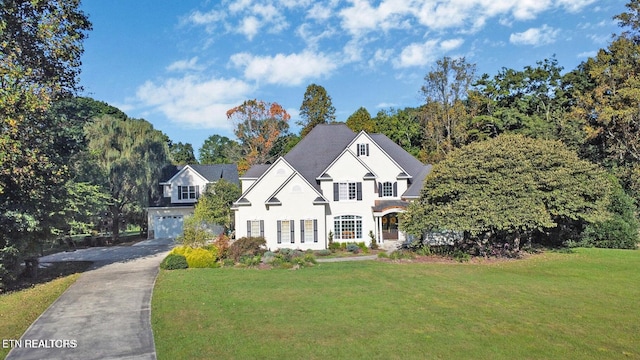 view of front of property with a front yard and a garage