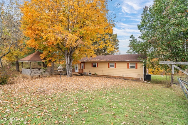 back of house with a lawn and cooling unit