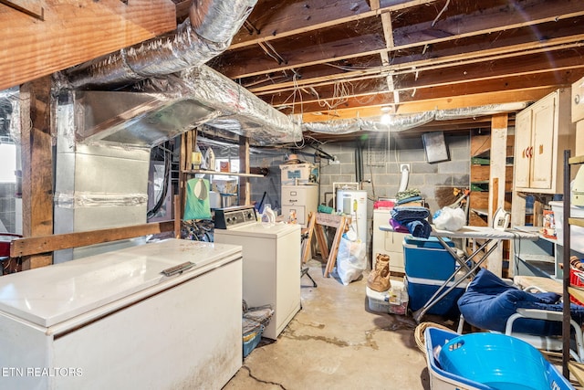 basement with washer and dryer and gas water heater