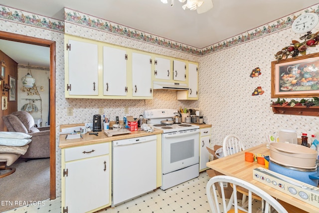 kitchen featuring white cabinetry and white appliances