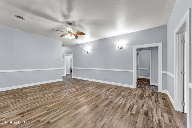 unfurnished room featuring dark hardwood / wood-style floors, a textured ceiling, and ceiling fan