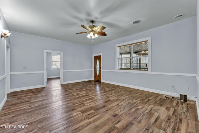 empty room with dark hardwood / wood-style floors and ceiling fan