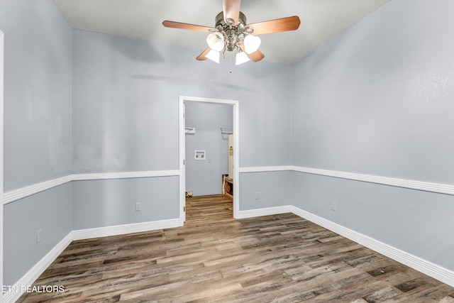 empty room featuring wood-type flooring and ceiling fan