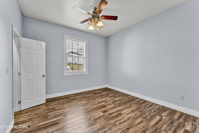 unfurnished room with ceiling fan and dark hardwood / wood-style flooring