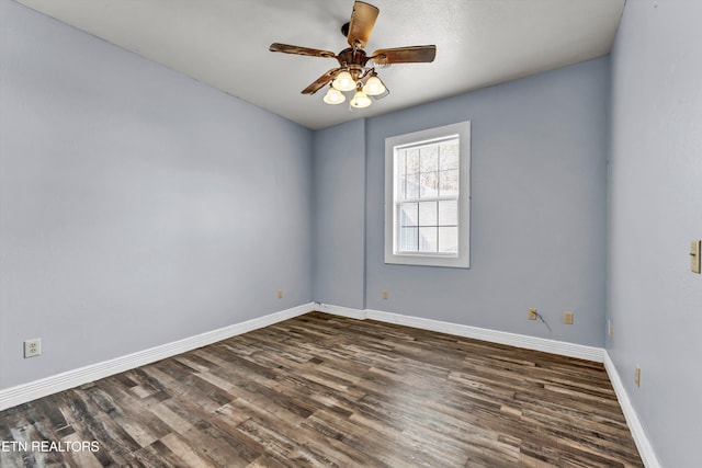 spare room with ceiling fan and dark hardwood / wood-style floors